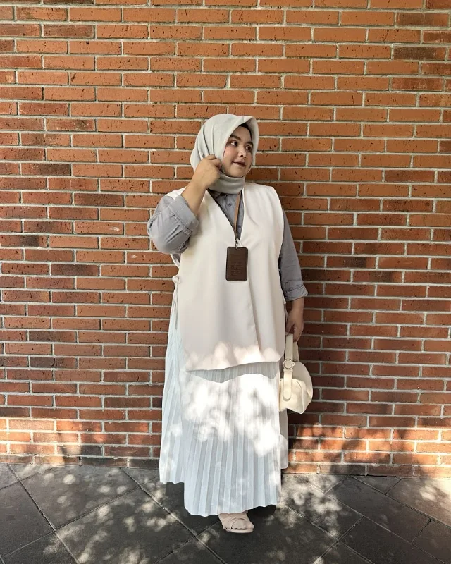 Neutral Layered Vest and Pleated Skirt